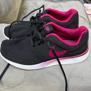 Pink and white Nike running shoes